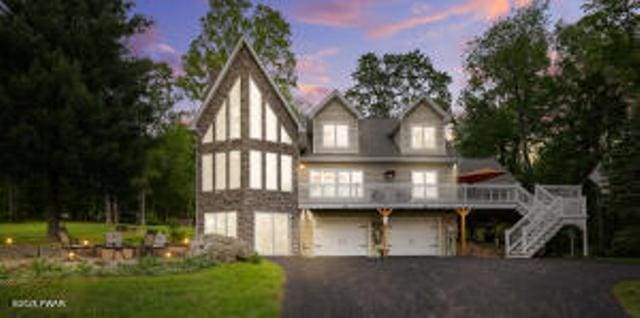 7 Shore Line Dr, Lakeville, PA 18438 - view of front of house with a garage, driveway, stairs, and a deck