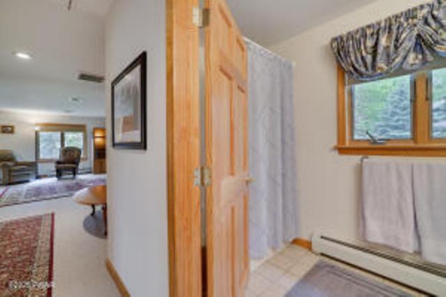 7 Shore Line Dr, Lakeville, PA 18438 - corridor featuring baseboard heating and baseboards