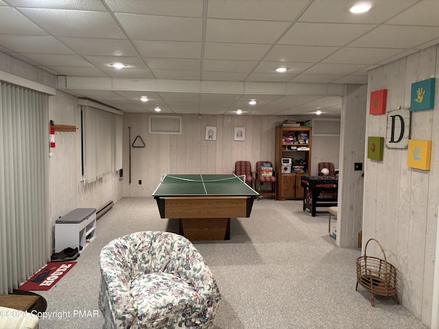 playroom featuring wooden walls, a drop ceiling, baseboard heating, carpet floors, and recessed lighting