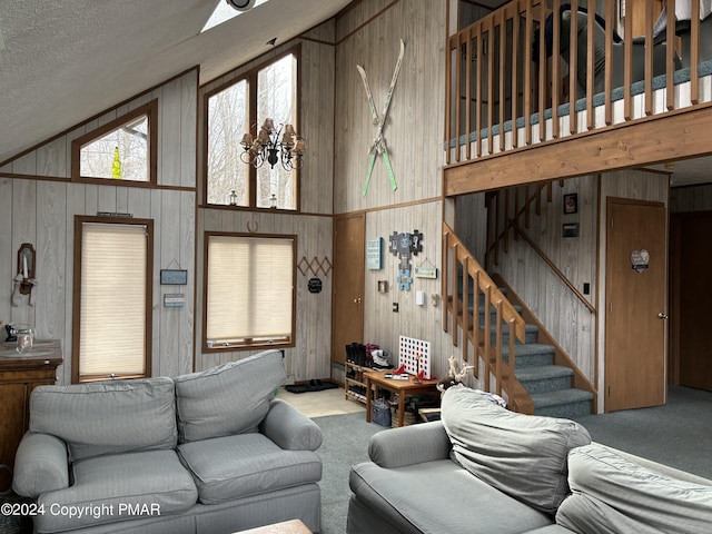 carpeted living room with stairs, lofted ceiling, and wooden walls