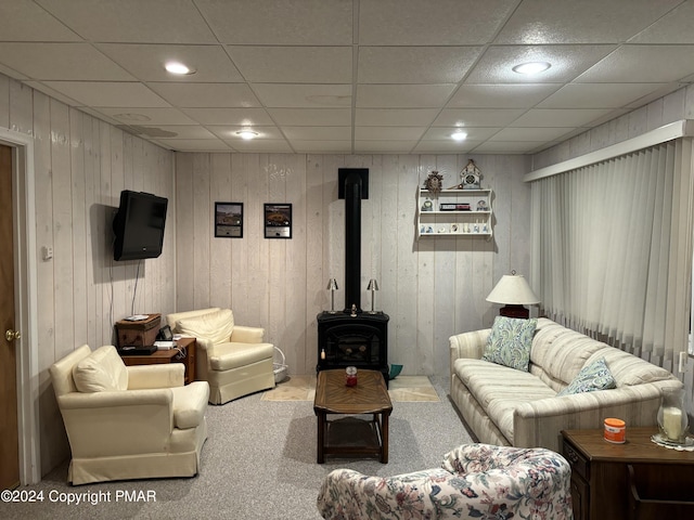 living room featuring a wood stove, carpet floors, and recessed lighting