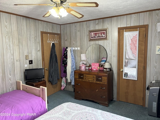 bedroom featuring a textured ceiling, carpet, and crown molding