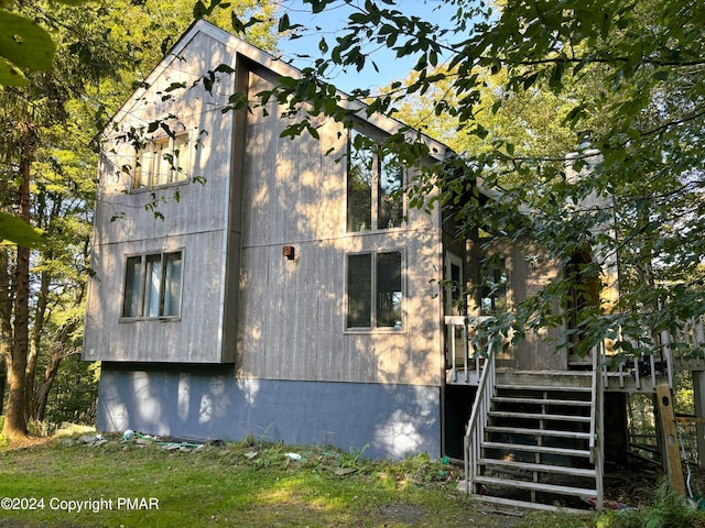 view of property exterior featuring stairs