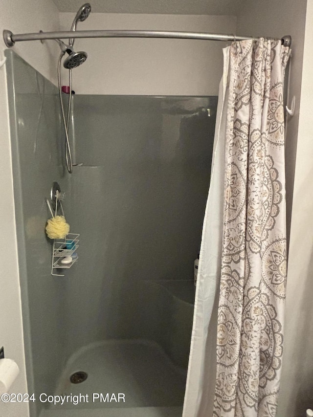 full bath with a shower stall