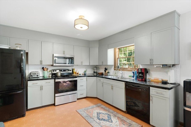 114 Gregory Ct, Stroudsburg, PA 18360 - kitchen with black appliances, dark countertops, tasteful backsplash, and light floors