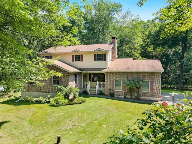 114 Gregory Ct, Stroudsburg, PA 18360 - traditional-style home featuring a porch, a front yard, a chimney, and brick siding