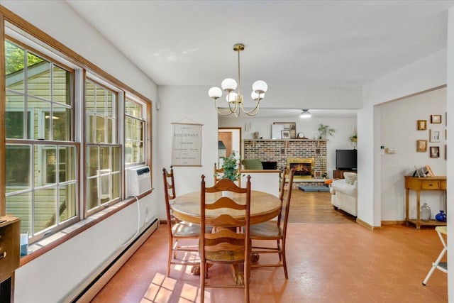 114 Gregory Ct, Stroudsburg, PA 18360 - dining room with baseboard heating, a fireplace, light floors, and a chandelier