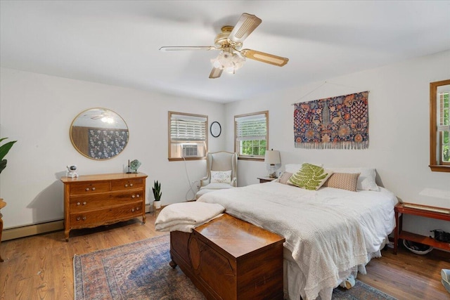 114 Gregory Ct, Stroudsburg, PA 18360 - bedroom featuring a baseboard radiator, multiple windows, wood finished floors, and cooling unit