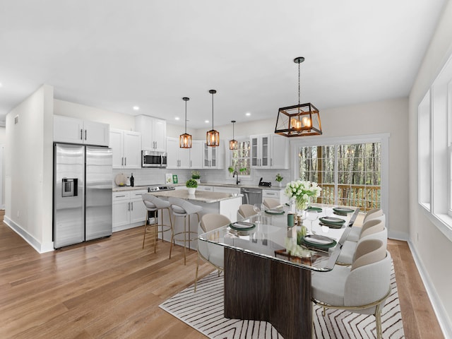 26 Susquehanna Dr, Jim Thorpe, PA 18229 - dining room featuring healthy amount of natural light, light wood finished floors, a chandelier, and recessed lighting