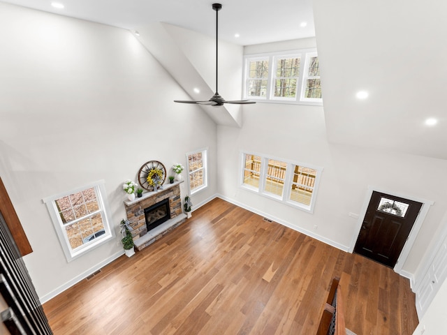 26 Susquehanna Dr, Jim Thorpe, PA 18229 - living room featuring a high ceiling, a fireplace, recessed lighting, ceiling fan, and wood finished floors