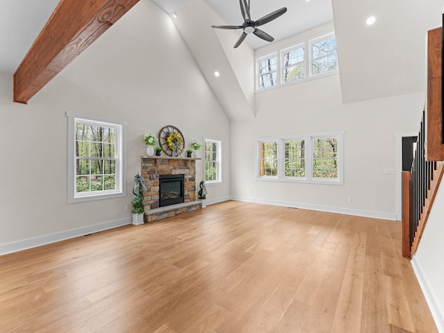 26 Susquehanna Dr, Jim Thorpe, PA 18229 - unfurnished living room with high vaulted ceiling, a ceiling fan, a fireplace, light wood-type flooring, and stairs