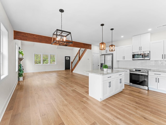 26 Susquehanna Dr, Jim Thorpe, PA 18229 - kitchen featuring appliances with stainless steel finishes, light wood finished floors, backsplash, hanging light fixtures, and recessed lighting
