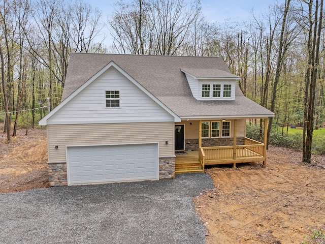 26 Susquehanna Dr, Jim Thorpe, PA 18229 - view of front of house with stone siding, a shingled roof, driveway, a porch, and an attached garage
