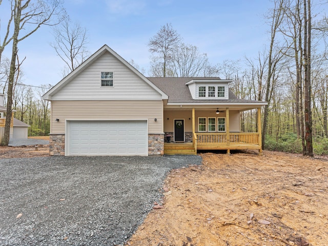 26 Susquehanna Dr, Jim Thorpe, PA 18229 - view of front facade featuring covered porch, stone siding, driveway, and roof with shingles