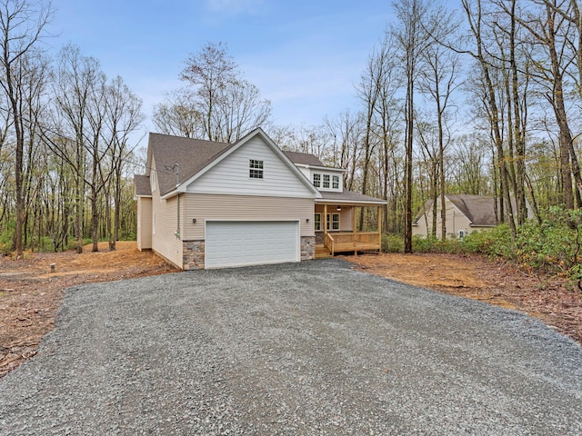 26 Susquehanna Dr, Jim Thorpe, PA 18229 - view of front of house with a porch, stone siding, gravel driveway, and a shingled roof