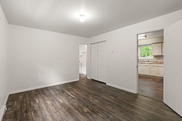 1221 Alder Rd, East Stroudsburg, PA 18302 - unfurnished room featuring dark wood-style flooring, baseboards, a sink, and baseboard heating