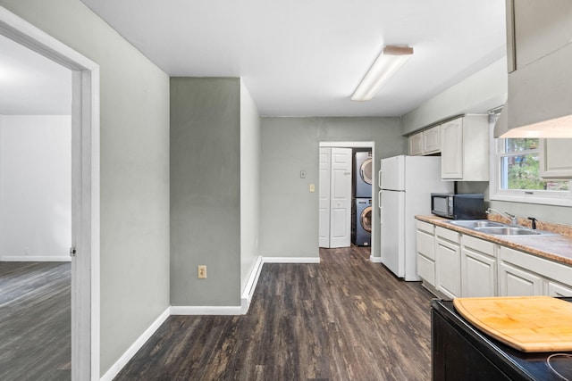 1221 Alder Rd, East Stroudsburg, PA 18302 - kitchen with stacked washer / dryer, black microwave, a sink, dark wood finished floors, and white cabinetry