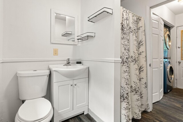 1221 Alder Rd, East Stroudsburg, PA 18302 - full bathroom featuring estacked washer and dryer, wood finished floors, vanity, toilet, and a shower with curtain
