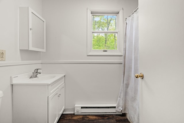 1221 Alder Rd, East Stroudsburg, PA 18302 - full bathroom with baseboard heating, vanity, toilet, and wood finished floors