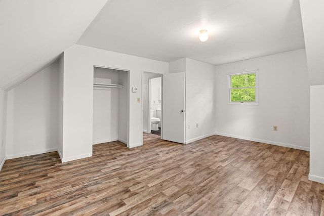 1221 Alder Rd, East Stroudsburg, PA 18302 - unfurnished bedroom featuring wood finished floors, baseboards, a closet, and lofted ceiling