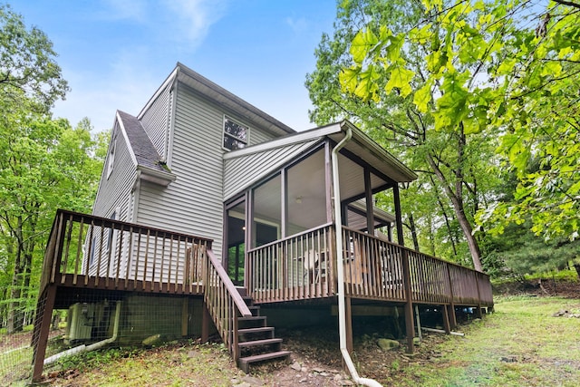 1221 Alder Rd, East Stroudsburg, PA 18302 - back of property with a wooden deck, a sunroom, and stairway