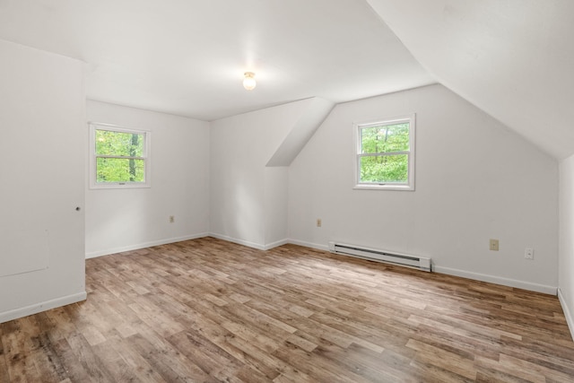 1221 Alder Rd, East Stroudsburg, PA 18302 - additional living space with a baseboard heating unit, healthy amount of natural light, wood finished floors, lofted ceiling, and baseboards