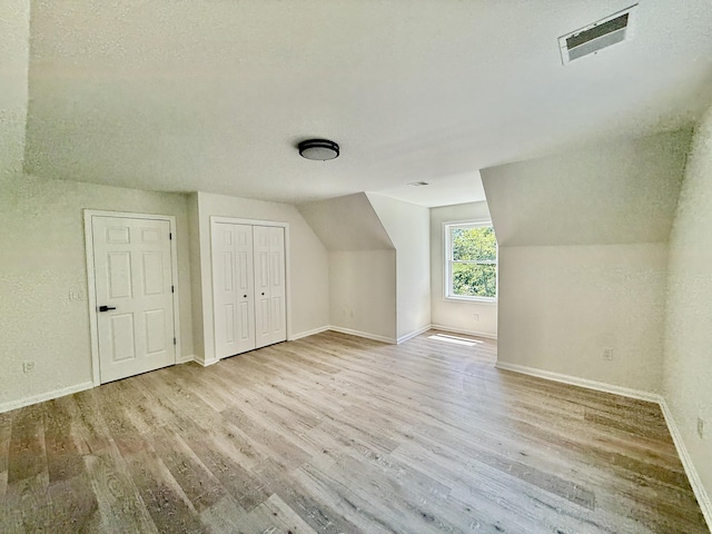 459 Pocono Blvd, Bushkill, PA 18324 - additional living space featuring wood finished floors, vaulted ceiling, and a textured ceiling