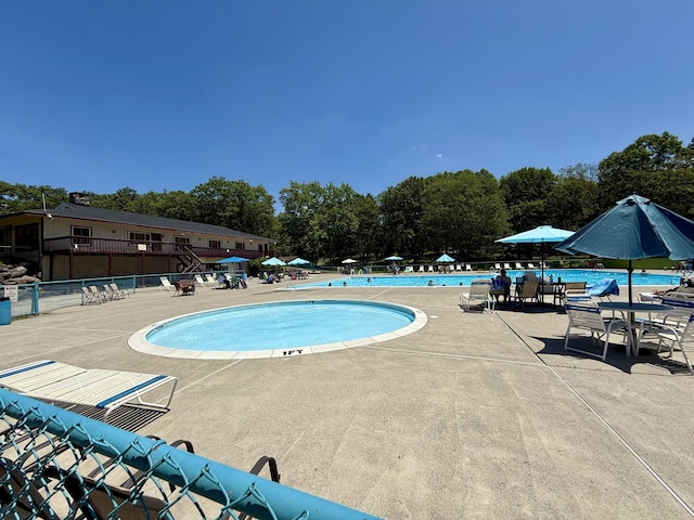 459 Pocono Blvd, Bushkill, PA 18324 - community pool featuring a patio and view of wooded area