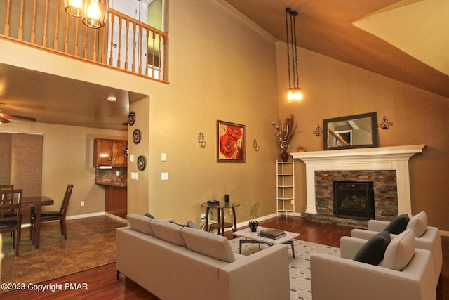 158 Davis Cir, Bushkill, PA 18324 - living room with wood finished floors, ceiling fan, a fireplace, and high vaulted ceiling