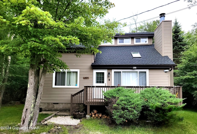 view of front of house featuring a deck, roof with shingles, and a chimney