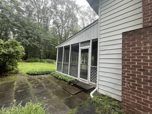 122 Savage Trl, East Stroudsburg, PA 18301 - view of side of property with a sunroom, a patio area, and a lawn
