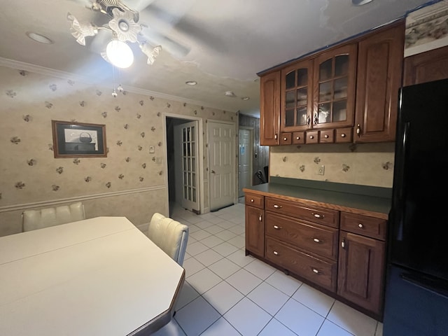 122 Savage Trl, East Stroudsburg, PA 18301 - kitchen with freestanding refrigerator, crown molding, wallpapered walls, light tile patterned floors, and glass insert cabinets
