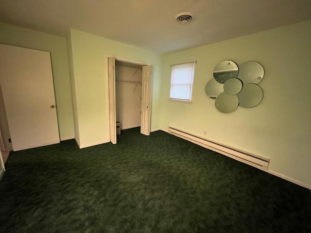 122 Savage Trl, East Stroudsburg, PA 18301 - unfurnished bedroom with a baseboard heating unit, a closet, and dark colored carpet