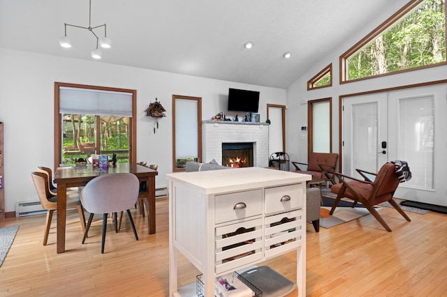 130 Ruffed Grouse Rd, Bushkill, PA 18324 - kitchen featuring a brick fireplace, light countertops, light wood-type flooring, recessed lighting, and high vaulted ceiling