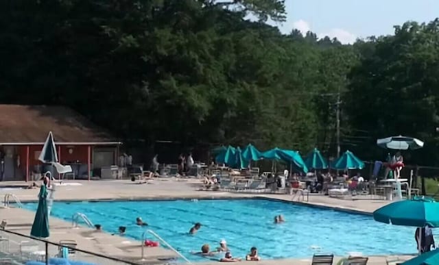 130 Ruffed Grouse Rd, Bushkill, PA 18324 - community pool with a patio, a water slide, and a wooded view