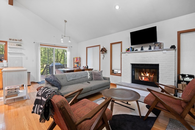 130 Ruffed Grouse Rd, Bushkill, PA 18324 - living area with light wood-style flooring, a brick fireplace, high vaulted ceiling, and recessed lighting