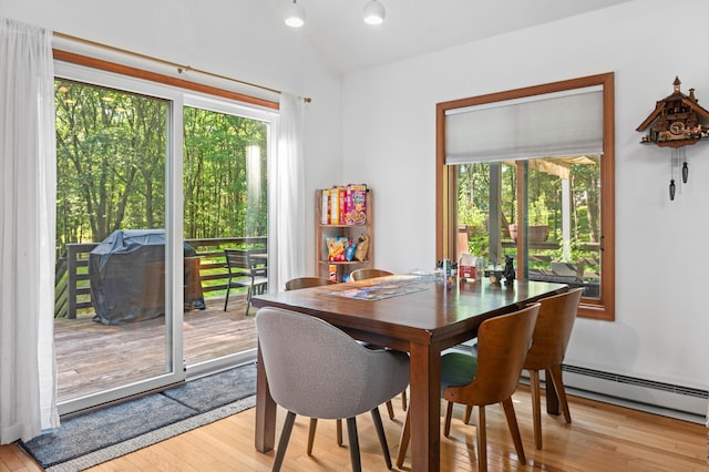 130 Ruffed Grouse Rd, Bushkill, PA 18324 - dining room with lofted ceiling, plenty of natural light, light wood finished floors, and baseboard heating