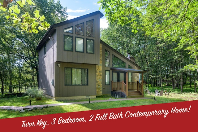 130 Ruffed Grouse Rd, Bushkill, PA 18324 - rear view of property featuring stone siding and a lawn
