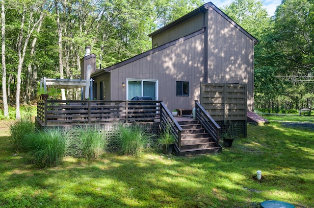 130 Ruffed Grouse Rd, Bushkill, PA 18324 - back of house with a yard, a wooden deck, and a chimney