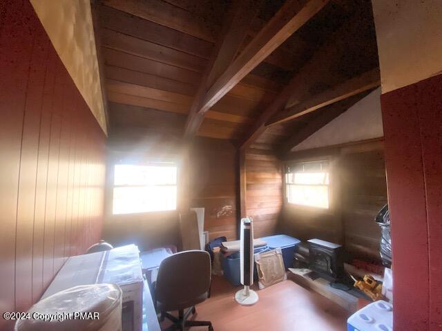 2086 Glenwood Ln, Lake Ariel, PA 18436 - office featuring vaulted ceiling with beams, wood walls, wooden ceiling, and a wood stove