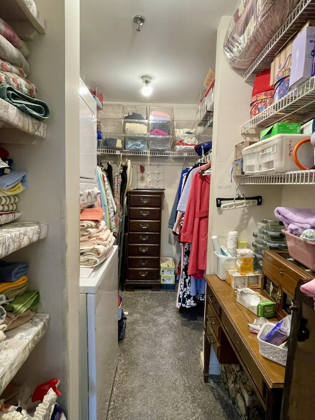 spacious closet featuring stacked washing maching and dryer