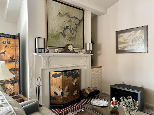 interior space featuring a glass covered fireplace and baseboards