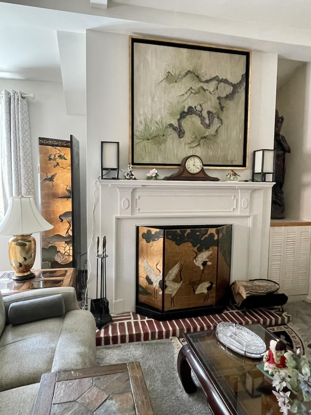 living room with a glass covered fireplace and carpet flooring