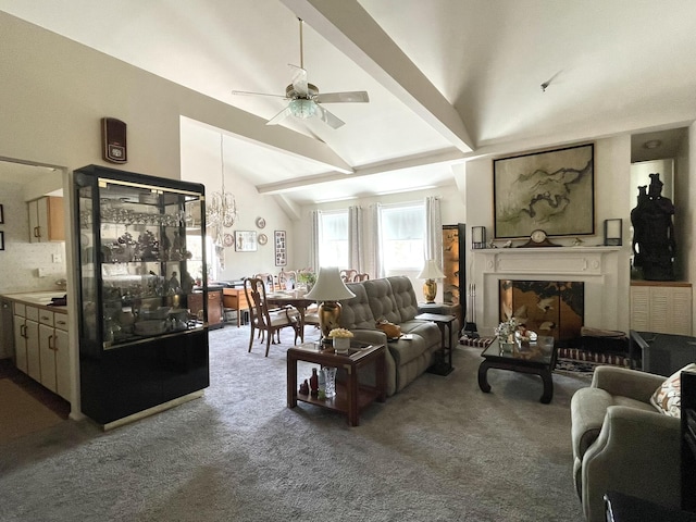 carpeted living area featuring ceiling fan with notable chandelier, vaulted ceiling with beams, and a premium fireplace