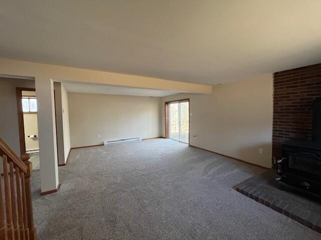 unfurnished living room with a wood stove, baseboards, carpet floors, and a baseboard radiator