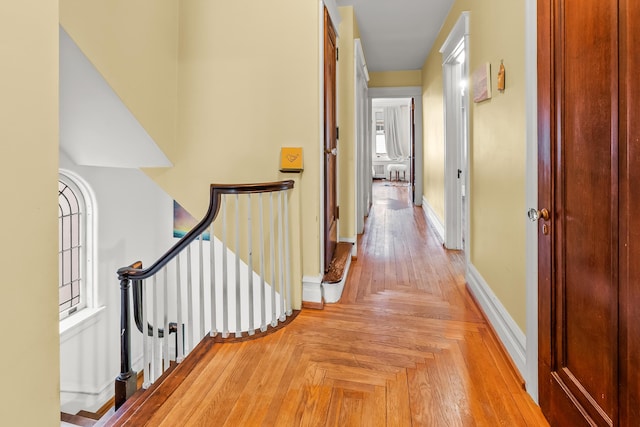 hallway featuring baseboards and an upstairs landing