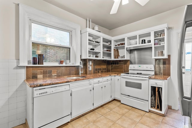 kitchen featuring open shelves, a sink, white appliances, stone counters, and light tile patterned floors