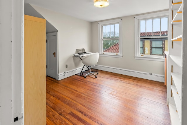 office featuring wood-type flooring, baseboards, and a baseboard radiator