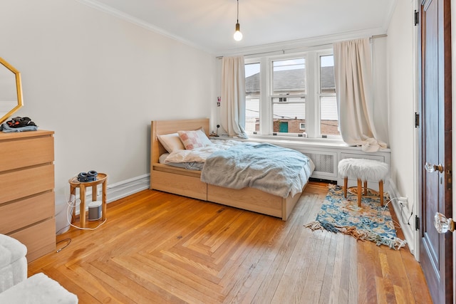 bedroom with crown molding and baseboards