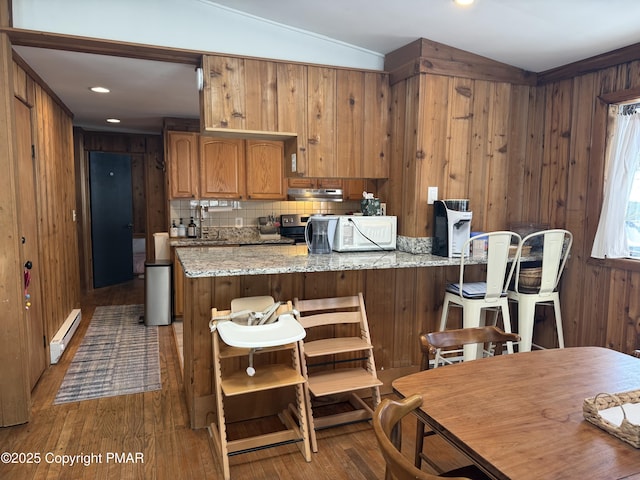 1827 Stag Run, Pocono Lake, PA 18347 - kitchen with wooden walls, white microwave, brown cabinetry, wood finished floors, and baseboard heating